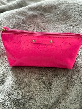 kate spade glossy hot pink cosmetic pouch with perforated logo